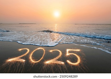 2025 text in sea sand and wave at ocean beach shore, sunset time	 - Powered by Shutterstock