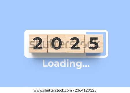2025 wooden cubes on blue background with loading bar