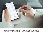 2026 Calendar event planner timetable agenda plan on organize schedule. Business woman using mobile phone with monthly calendar for event planning, Plan scheduling with laptop on office table
