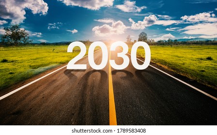 2030 written on highway road in the middle of empty asphalt road  and beautiful blue sky. Concept for vision 2030.