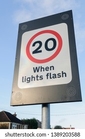 20mph Variable Speed Limit Sign Outside A School, Applicable When Lights Flash