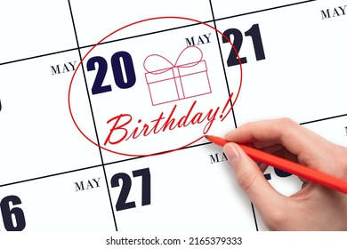 20th Day Of May. The Hand Circles The Date On The Calendar 20 May, Draws A Gift Box And Writes The Text Birthday. Holiday. Spring Month, Day Of The Year Concept.