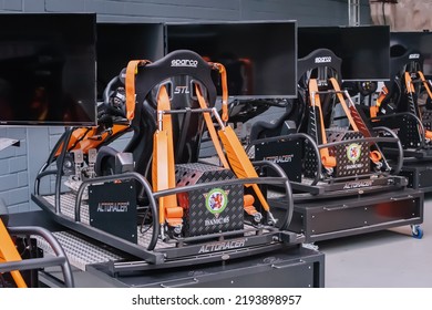 21 July 2022, Dusseldorf, Germany: Professional Simulator And Trainer Of A Racing Driver With A Chair With Levers And Multiple Monitors