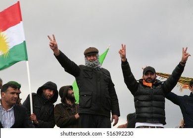 21 March 2015 - TURKEY. Kurds Of Iraq, With Hand Palm Showing Victory Sign, During Newroz Festival In Diyarbakir. In Background A Flag Of Kurdistan Region By The Iraqi Constitution.