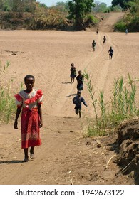 21 October 2005. African Village Children  Walking Across The Dry River Bed Of The Lupande River In Eastern Province, Zambia During The Dry Season.