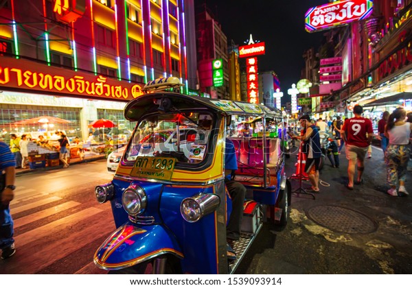 21 October,2019 Bangkok, Thailand Famous\
moto-taxi called tuk-tuk is a landmark of the city and popular\
transport, Tuk tuk on the street in Chinatown, street food night\
market in bangkok thailand.