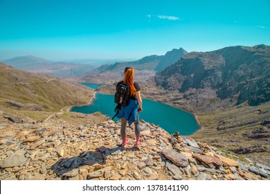  21/04/2019 Snowdonia, Wales .People Hiking and looking across beautiful Snowdon  mountain landscape. Snowdon mountain is located in Snowdonia National Park,Wales ,United Kingdom. 