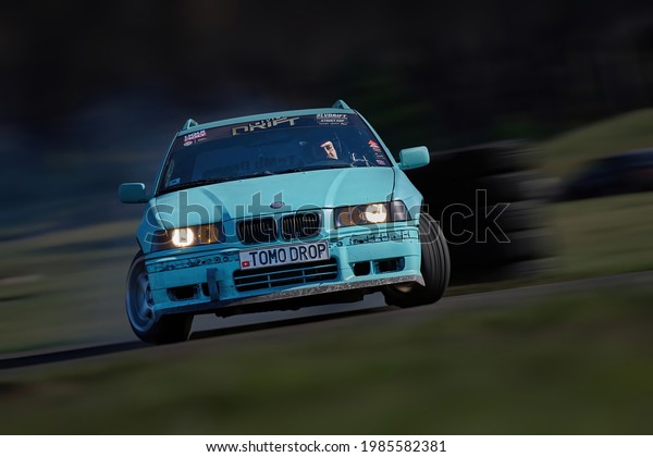 21-05-2021 Riga, Latvia Blurred car
drifting, motion blur car drift with whit smoke on race
track.