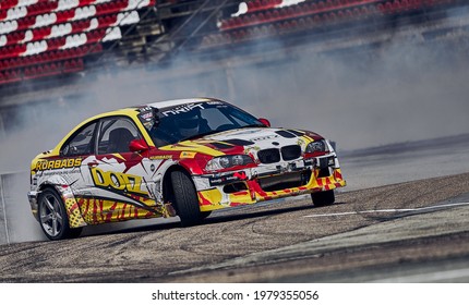 21-05-2021 Riga, Latvia Car Drifting On Asphalt Racing Track With Lot Of Smoke, Motion Blur Drift Car..