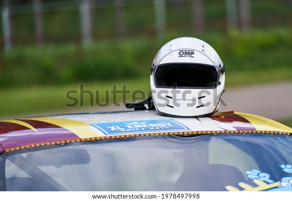 21-05-2021 Riga, Latvia racing helmet on top of a\
racing car.