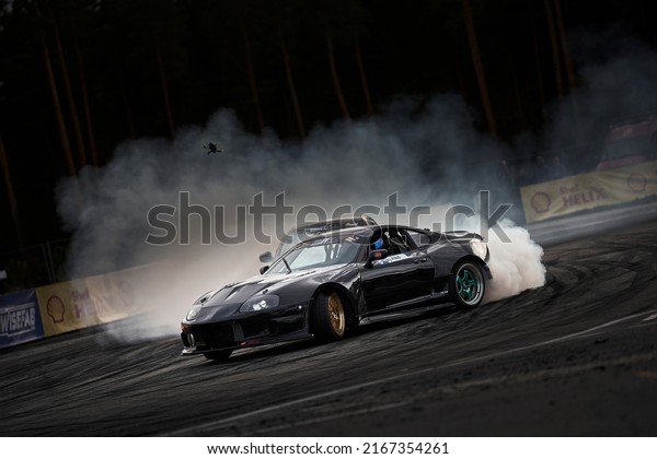 21-05-2022 Riga, Latvia\
car drifting on asphalt racing track with lot of smoke, motion blur\
drift car..