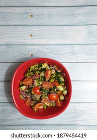 21.12.2020, Kuala Lumpur, Malaysia: A Red Tupperware Bowl Of Salad Mixed With Winged Beans, Japanese Cucumber, Cherry Tomatoes, Onions, Honey, Squeezed Musk Lime And Sprinkled With Chia Seed.