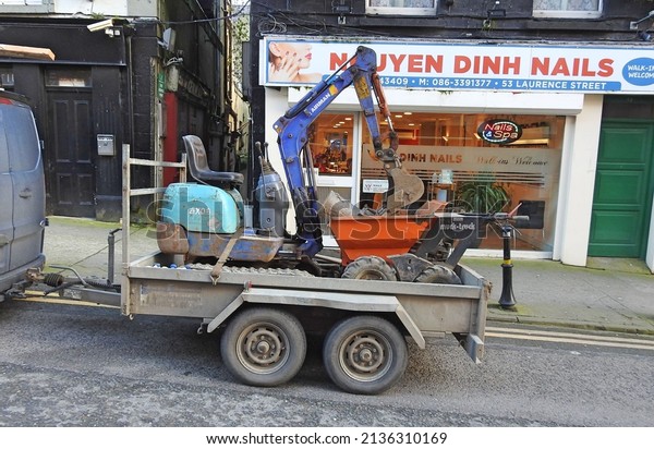 21st\
February 2022, Drogheda, Ireland. Trailer with a muck truck mini\
digger on Laurence Street, Drogheda Town Centre.\
