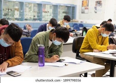 22 01 2021 Male And Female Students Doing Course Or Paper Work In Classroom With Face Mask In University In Hong Kong During Covid-19