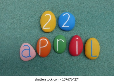 22 April, calendar date with colored stones over green sand