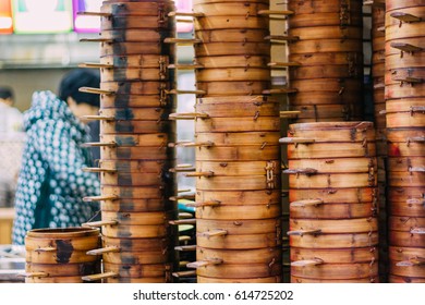 22,Dec,2015,Chong Qing, Column Of  Steamer Baskets Of Dim Sum, A Chinese Women Wokring Behind It Selling Chinese Food