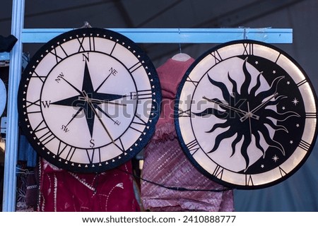 22nd December, 2022, Kolkata, West Bengal, India: Old analog compus hanging whit big antique clock for sale at International trade fair, Kolkata.