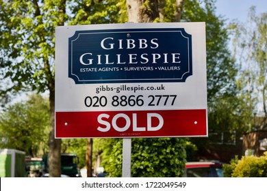 23 April 2020 - England, UK: Estate Agent's House Sold Sign In Front Of A Tree