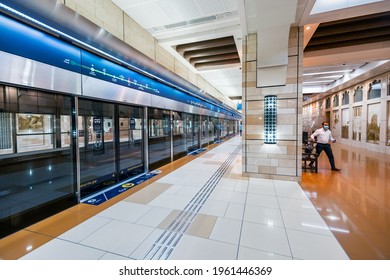 23 February 2021, Dubai, UAE: Passenger With Face Medical Mask Enter The Arriving Train Car In The Metro Al Ghubaiba Station