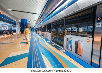 23 February 2021, Dubai, UAE: Passengers Enter The Arriving Train Car In The Metro