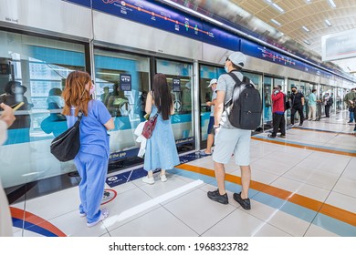 23 February 2021, Dubai, UAE: Passengers Enter The Arriving Train Car In The Metro