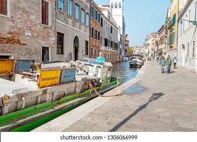 23 OCTOBER 2018, VENICE, ITALY: The boat with garbage on the venetian channel. Recycle of rubbish and trash and municipal service concept
