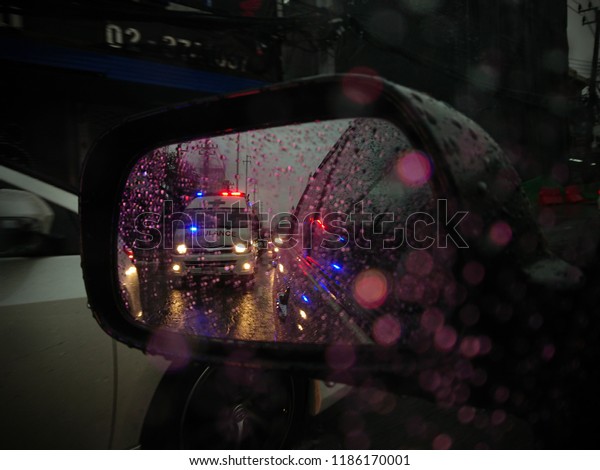 23 Sep. 2018, Raining day, Ambulance opening the\
siren drive through traffic jam on Ramkhamhang Rd., Bangkapi,\
Bangkok, Thailand