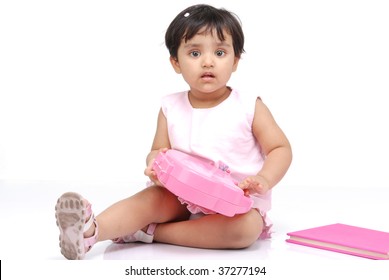 2-3 Year Old Baby Girl Sitting With Box And Book