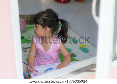 Similar – Funny child looking at the camera and painting