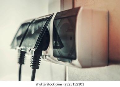 230 Volts European Electrical Wall Outlets with Two Cords Attached Closeup Photo. 