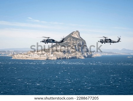 230412-N-MW880-1136 STRAIT OF GIBRALTAR (April 12, 2023) An MH-60S Nighthawk helicopter, attached to Helicopter Sea Combat Squadron (HSC) 5, and an MH-60R Sea Hawk helicopter