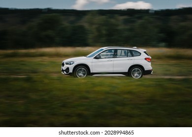 23-july-2021 - White Bmw X1 Driving Fast On A Gravel Road