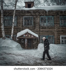 23rd Of February 2019, Russia, Tomsk, Older Man Walks By Old Wooden Building