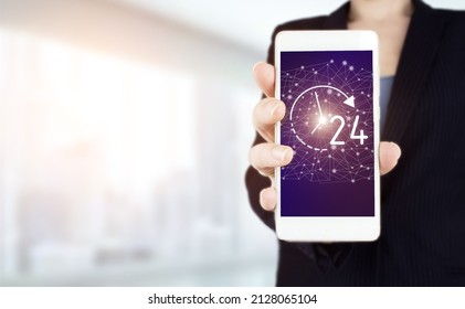 24 7 All Day All Night. Hand Hold White Smartphone With Digital Hologram 24 7 All Day All Night Sign On Light Blurred Background