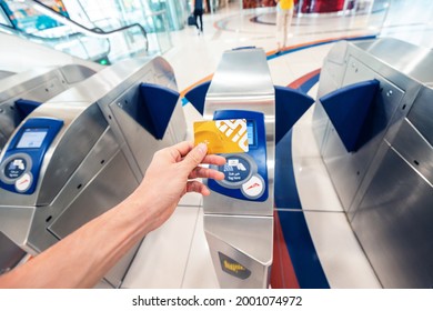 24 February 2021, Dubai, UAE: passenger applies a gold VIP card for passing through the turnstile in the Dubai metro and for traveling in the first car