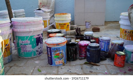 24 February 2021-Khatoo, Jaipur, India. Many Paint Pot With Paint Brush. Used Old Paint Can With Different Colors Holding On Ground. Color Cans Closeup.