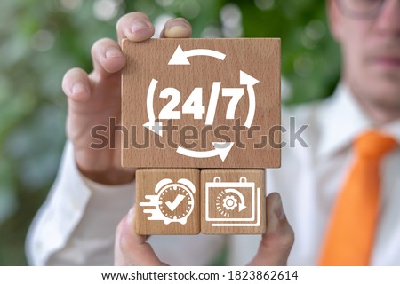 24 hours 7 days a week business open work concept. Businessman holding wooden blocks with 24/7 and round arrows icon.