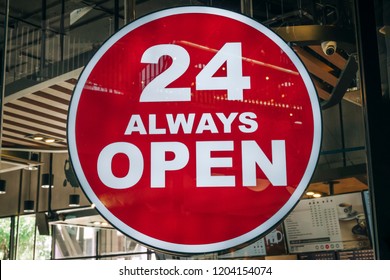 24 Hours Always Open Sign in front of the regular coffee cafe or co-working space in the city new trend of working space