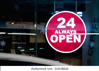 24 Hours Always Open Sign in front of the regular coffee shop in the city