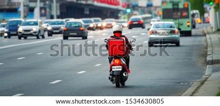 24 hours delivery service from cafes and restaurants. Takeaway, delivery boy on scooter with red isothermal backpack driving fast. Courier delivering food on motorbike to avoid evening traffic jams