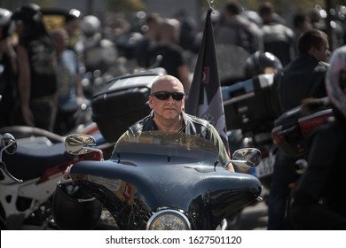 24-04-2019 Riga, Latvia. Serious Man In Sunglasses Sitting On Black Chopper.