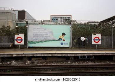 25 January 2020 - Wembley, UK: Advertising hoarding at underground station regarding air pollution and toxic air in London with platform and rails in the foreground