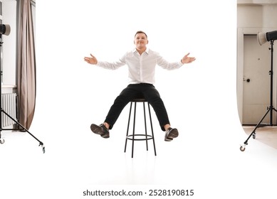 25 years man in a white shirt and blue tie sits on a chair. Concept of formal corporate photography - Powered by Shutterstock