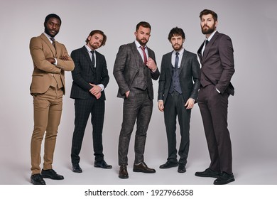 25 Years Old Male Leaders In Classic Suit Posing At Camera In Studio. Business People In Formalwear, Interracial Group Of Successful Men