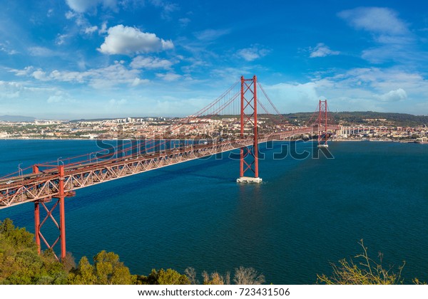 25th of April Bridge in Lisbon, Portugal in a\
beautiful summer day