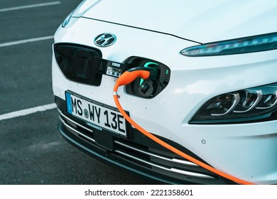 26 July 2022, Munster, Germany: Hyundai Modern Electric Car Is Charged In The Parking Lot. Environmental Awareness And Green Transport And The Transition To Renewable Energy Sources