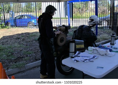 26 May 2018. Person Sharpening Knife At Stall Doing Business At Bondi Farmers Market, Sydney Australia. Tradesman At Work