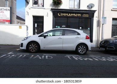 26th August 2020- A White Kia Rio SR7, Five Door Hatchback Car, Parked Outside Of An Indian Restaurant In The Town Center At Carmarthen, Carmarthenshire, Wales, UK,