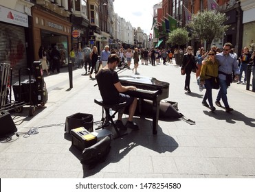 26th July 2019, Dublin, Ireland. Busker playing the piano on Grafton Street, Dublin city centre in the summer. 