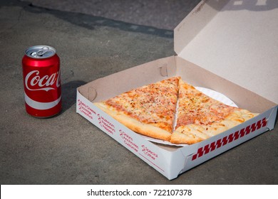 27 APRIL 2017 - NEW YORK - Legendary New York 0.99 Cents Slice Pizza In Box And Can Of Coca-cola On Grey Background